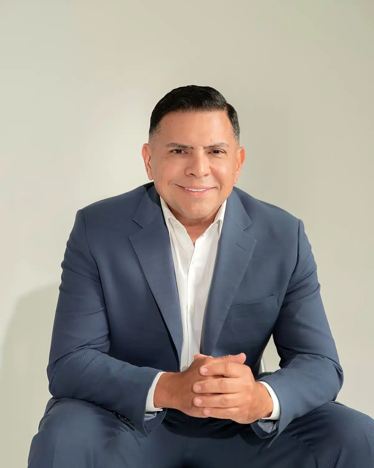 Attorney José O. Castañeda, Jr. seated and smiling
