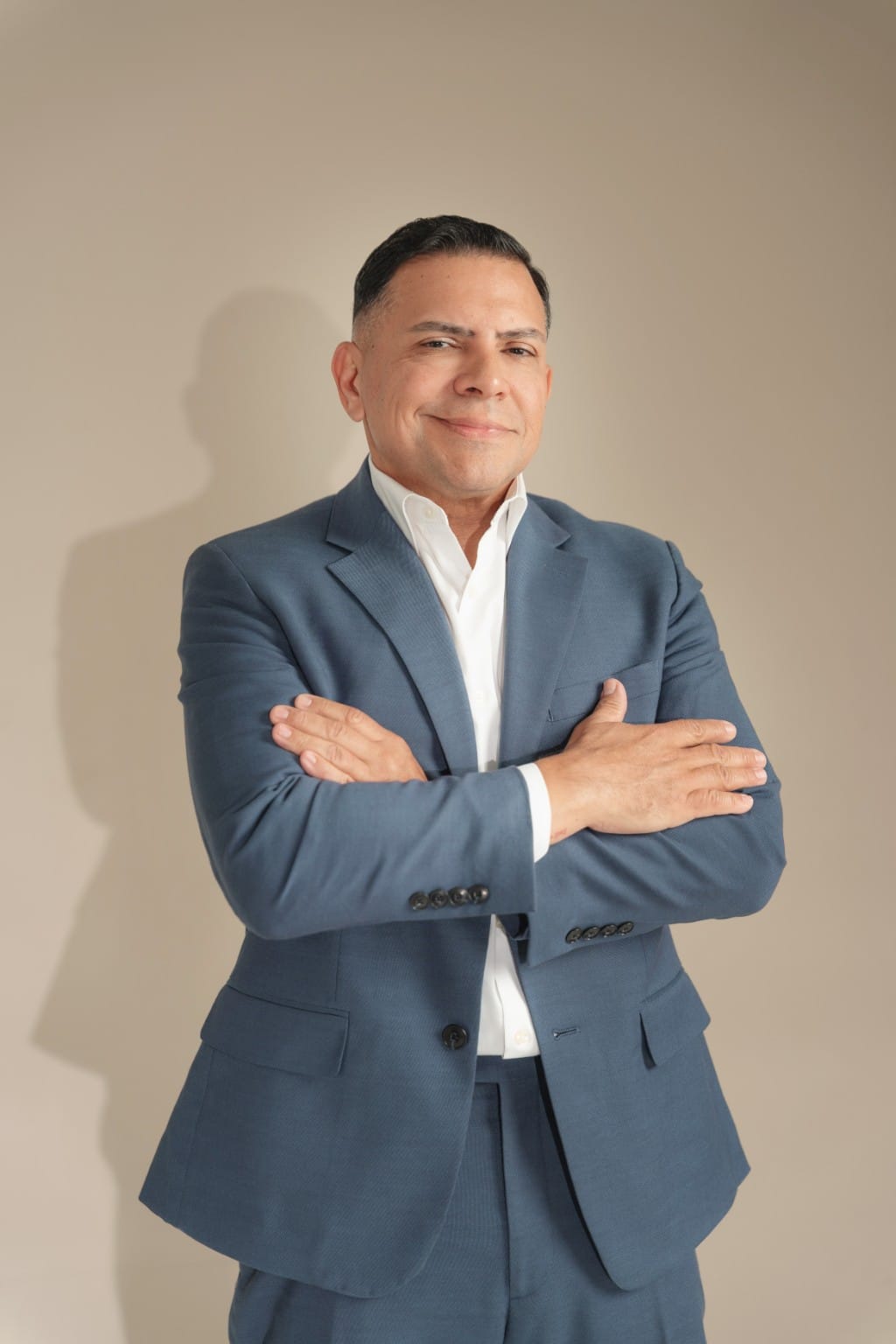 Attorney José O. Castañeda, Jr. standing with arms crossed and smiling