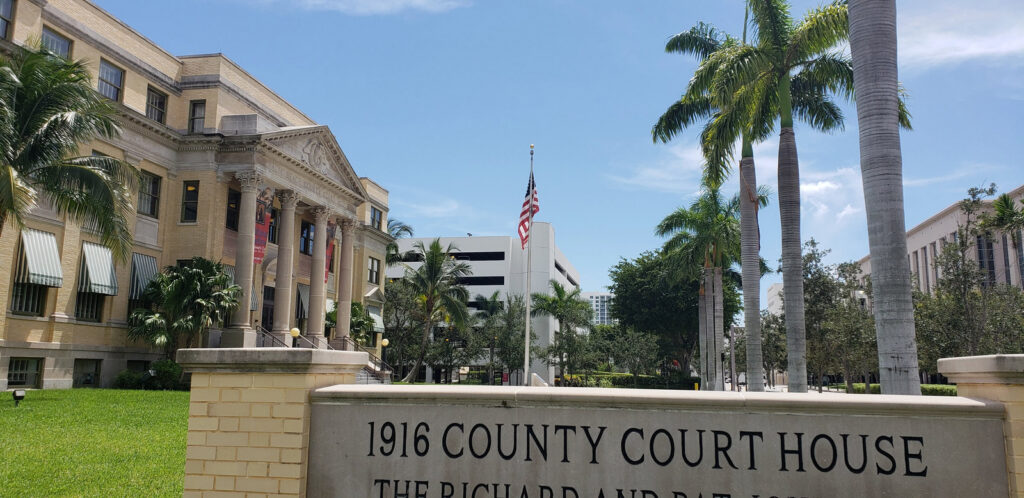 The 1916 Palm Beach County Courthouse and history-museum sign in West Palm Beach, Florida.