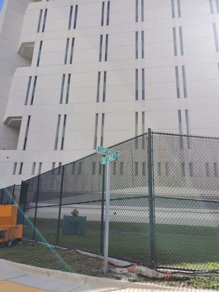 The Broward County Main Jail in Fort Lauderdale, Florida, viewed near the Courthouse Drive and Southeast First Avenue street signs.