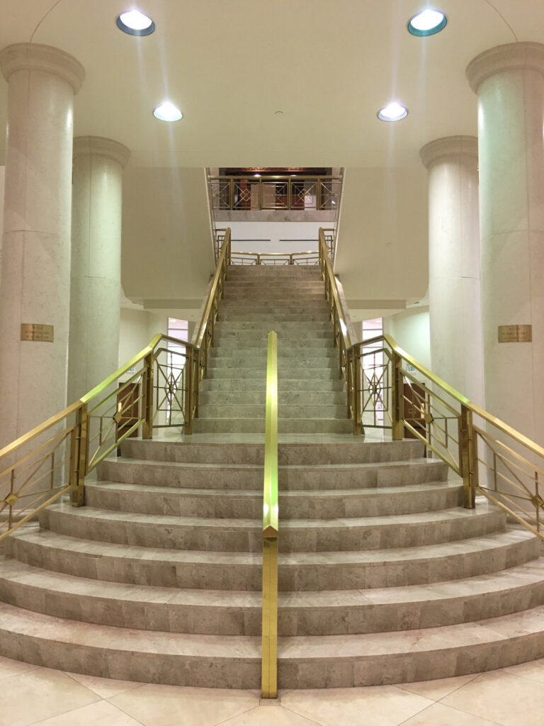 The central staircase, stone columns and brass railings inside the Palm Beach County South County Courthouse in Delray Beach, Florida.