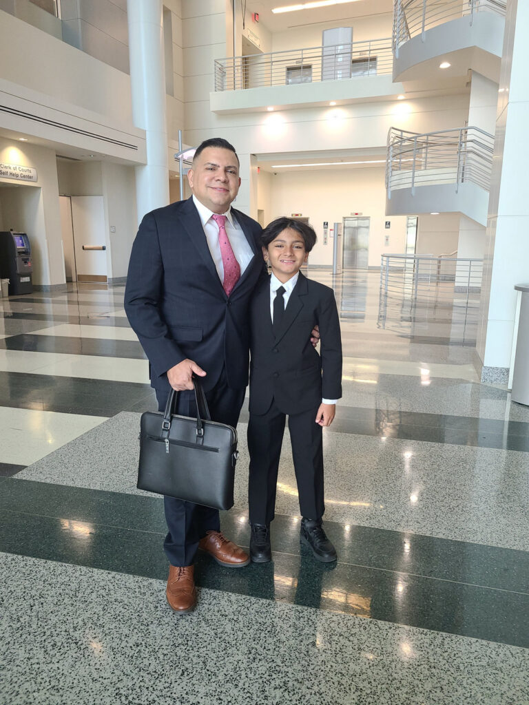 José O. Castañeda, Jr. with his son Esteban in the Collier County Courthouse atrium in Naples, Florida, during a bring-your-child-to-work visit.