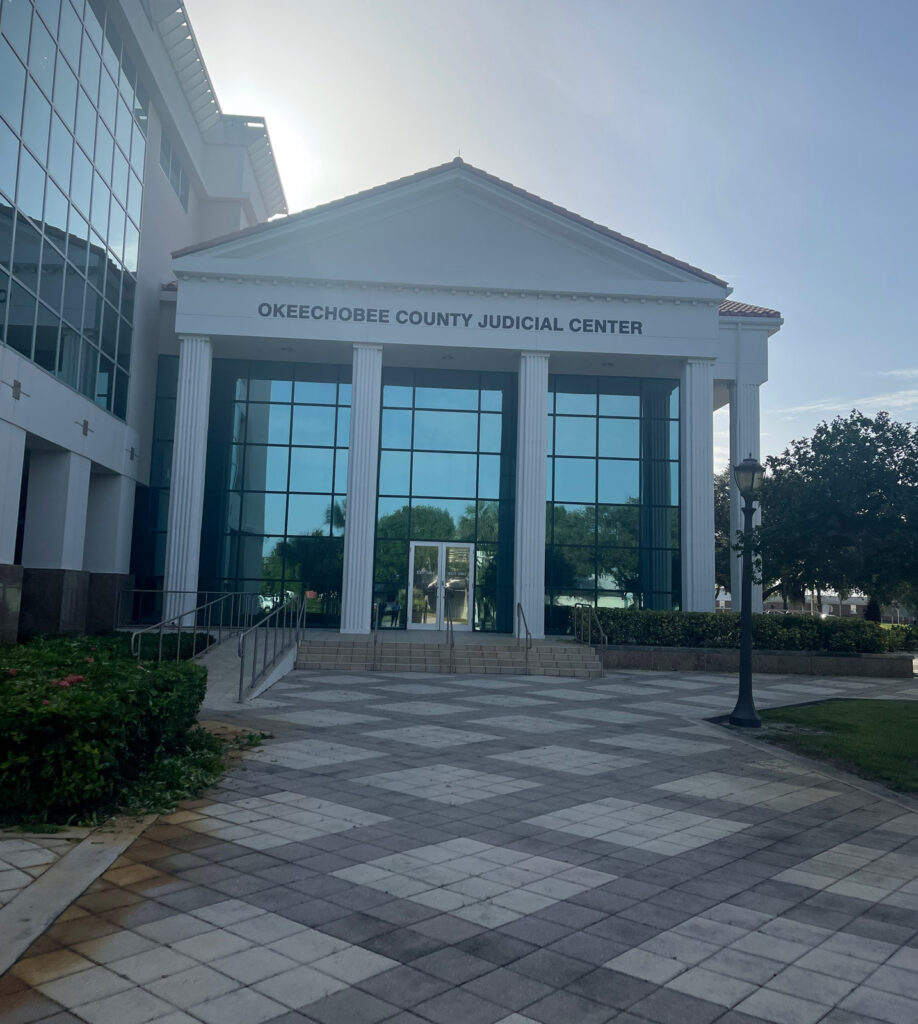 A wider exterior view of the Okeechobee County Judicial Center in Okeechobee, Florida.